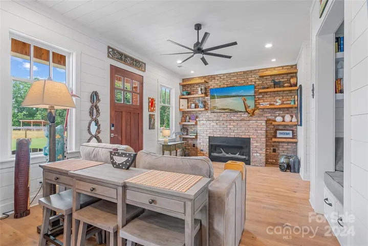 Ship lap walls, solid oak floors with oil rub finish, and a feature wall of antique brick make this living room a favorite destination!