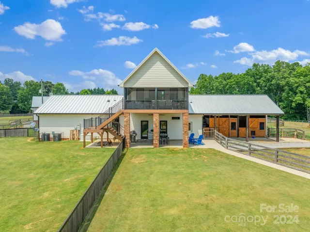Back facade of the home has several separate areas fenced in for pets.