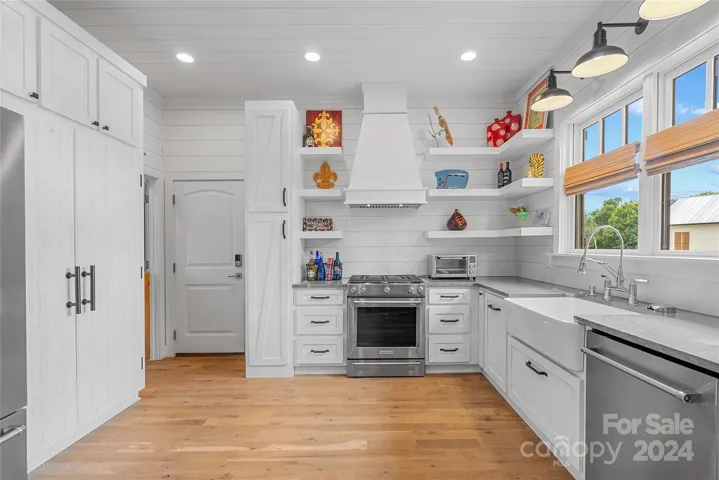 Kitchen with hand made custom cabinets, granite counters lots of storage and high end appliances. The door leads to a two car garage.