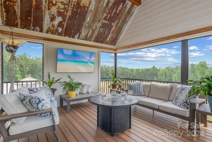 Elevated screened porch with decorative tin ceiling will be a favorite room!
