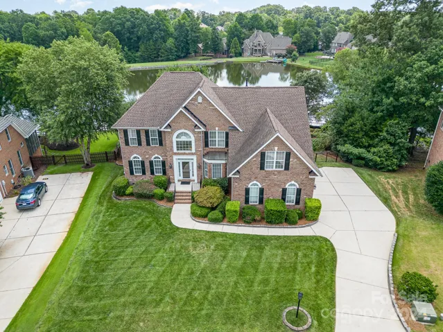 One of the very few homes in this neighborhood that back up to the lake.