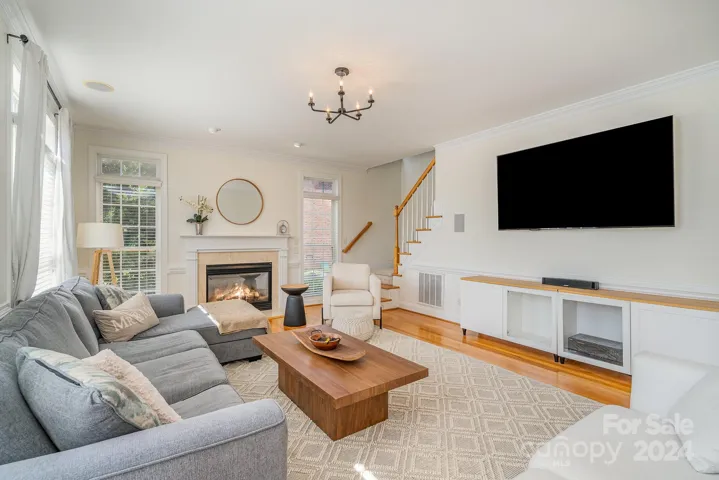 Warm and inviting family room with rear staircase leading to the bonus room, as well as the bedrooms.
