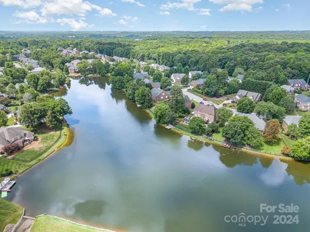 Looking across the lake at your new home - it's the one with the dock, the pool, and the laughter!