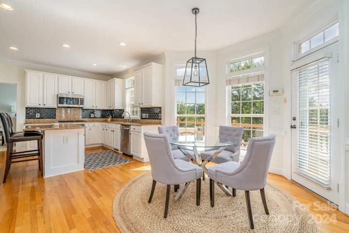 Informal dining area overlooking the lake, pool and the outdoor living areas