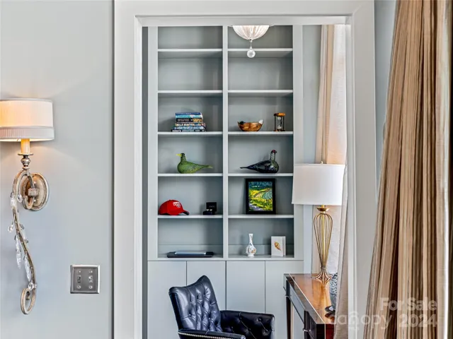 The office nook features built-in cabinetry and floor to ceiling windows.