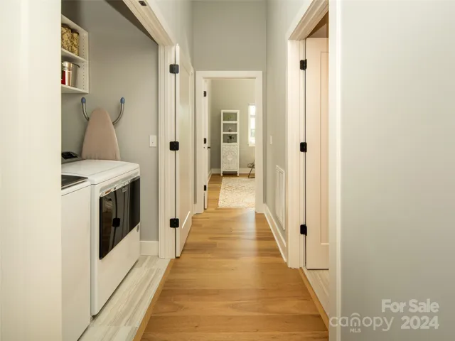 On the side of the hall is the laundry closet. Open the doors wide to work or  close them and put the laundry out of sight