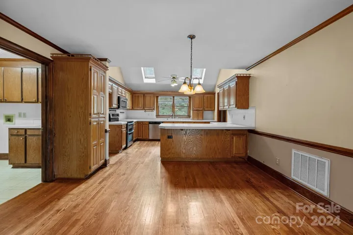 Hardwood floors extend into the kitchen.