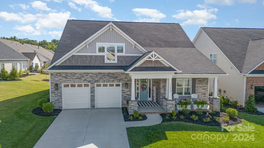 Large covered front porch with stone columns