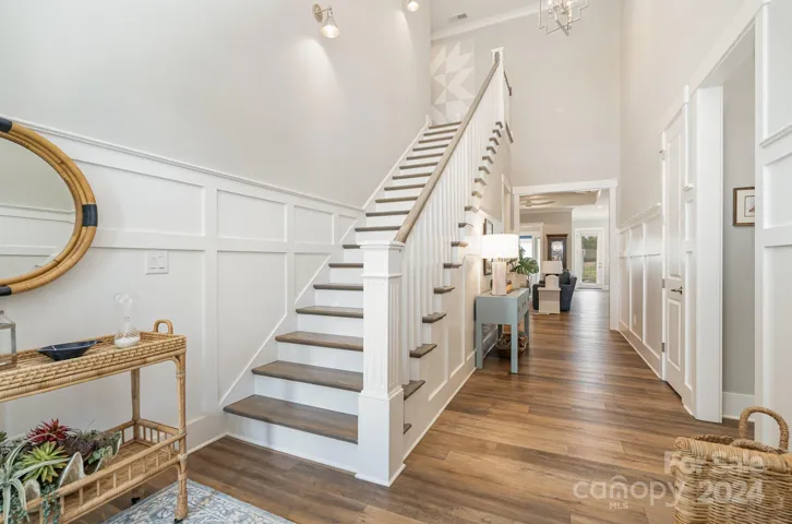 Lovely foyer with gorgeous wainscot, and light and bright entrance. Custom lighting throughout this lovely home