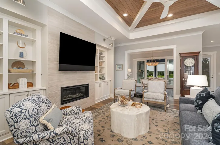 The great room is stunning. Note the custom ceiling and the built-ins