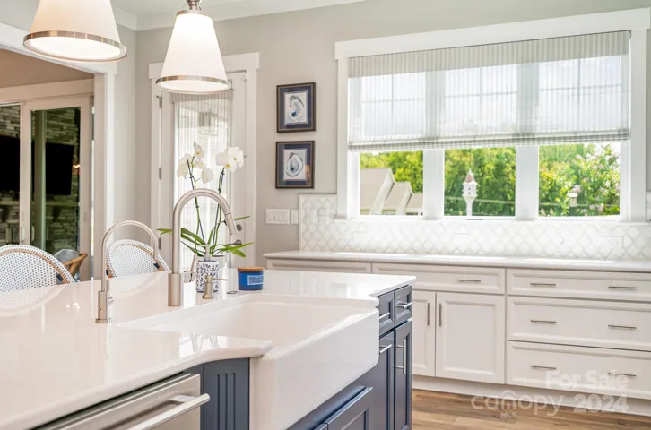 Farmhouse sink and custom lighting makes the island extra special
