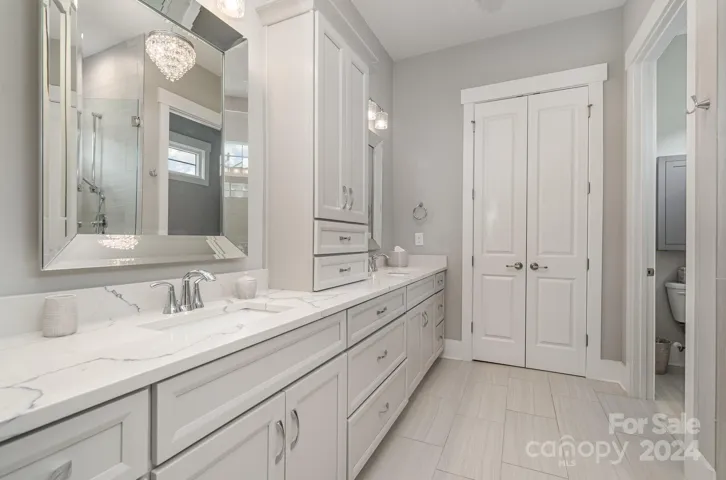 Gorgeous Primary Bath with luxury finishes and custom lighting. It is beautiful!