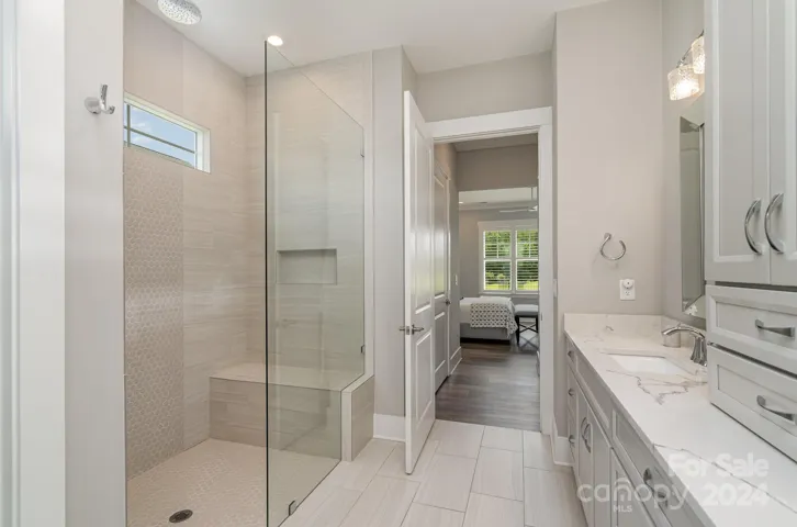 The shower features custom glass with a special coating to keep water spots from forming. If you are meticulous, this special glass is for you!