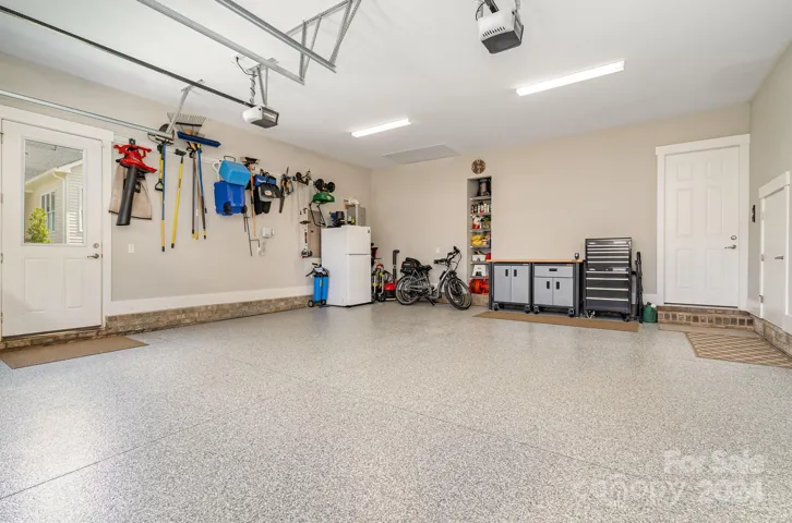 Not only does the home have incredible storage, it also has a super sized garage with an immaculate epoxy floor covering. Note the small door to the right with even more storage and the "door" in the ceiling where the Versa Lift is accessed from the garage. They have thought of everything!