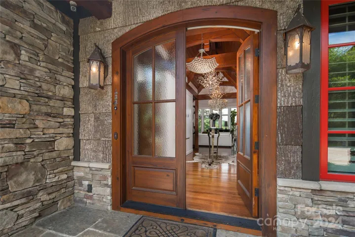Stone and Bark finishes on the exterior, custom wood and frosted glass double doors