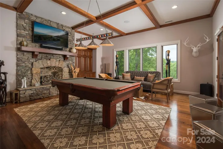 Lower floor bonus room with large fireplace and built in cabinets
