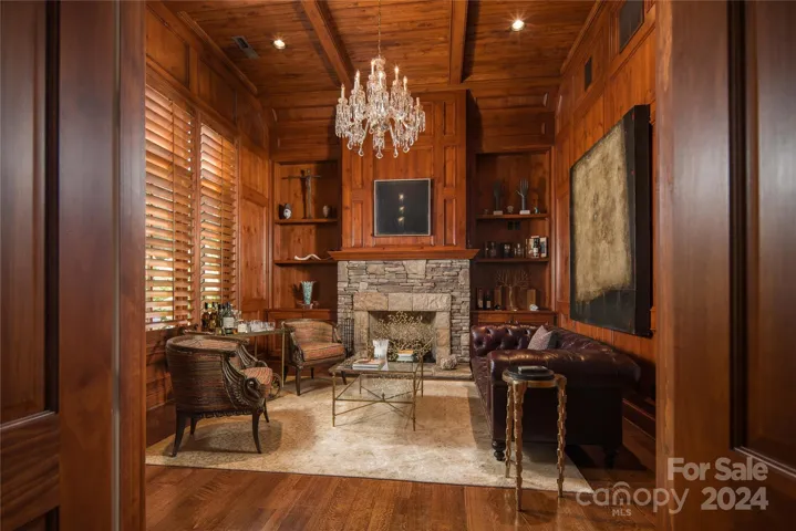 Den with custom wood and fireplace