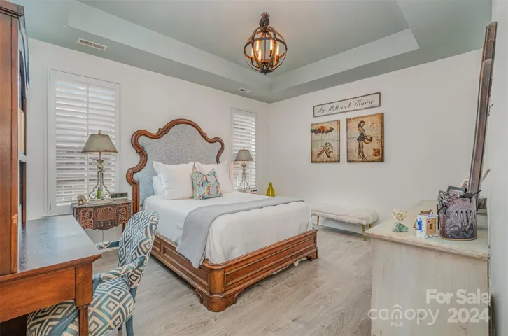 Primary Bedroom with Tray ceilings and Plantation Shutters