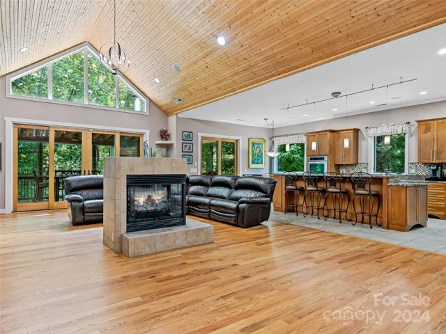 Open Design Featuring A 3-Sided Fireplace With Tile Hearth & Surround