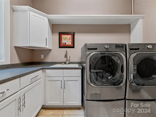 Laundry Room On The Main Level With Additional Storage Space
