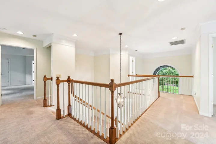 The open catwalk hallway allows light to fill upstairs.