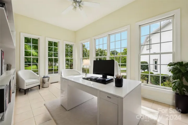 Virtually staged to show what a great workspace this room could be! Sunroom.