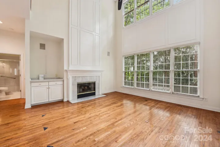 Open floor plan with split staircase leads to full bathroom + bedroom on the primary, just past the light filled family room!