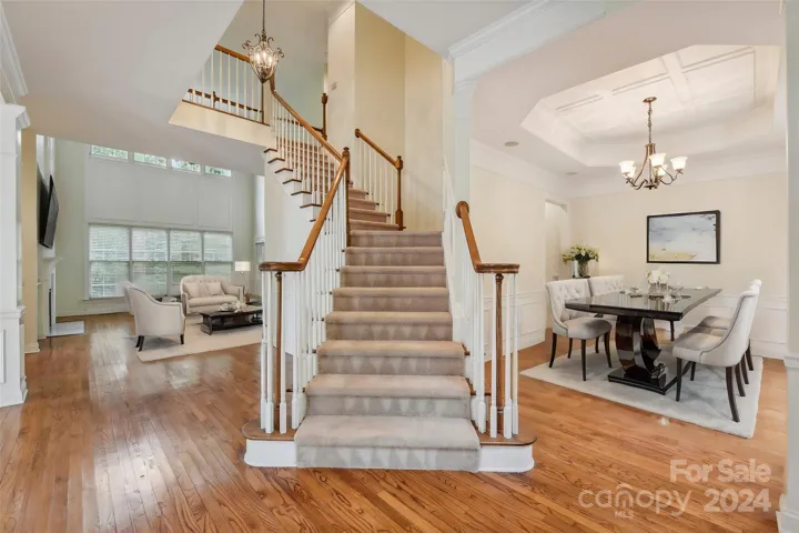 Staircase and formal dining room. Virtually staged.