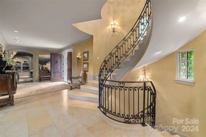 Main level stairway to second level and lower level. Foyer