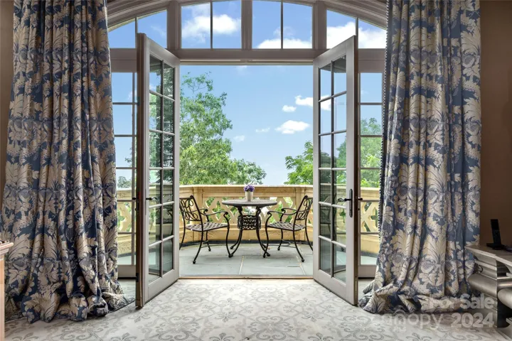 French Doors leads to Primary Balcony over looking the Blue Ridge Mountains