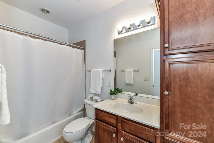 Full Bath features tub/shower, plenty of cabinets for storage & tile floors!