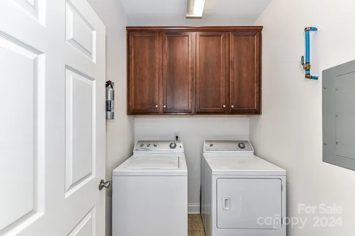 Laundry Room with cabinets for storage & tile floors (washer/dryer remain)!