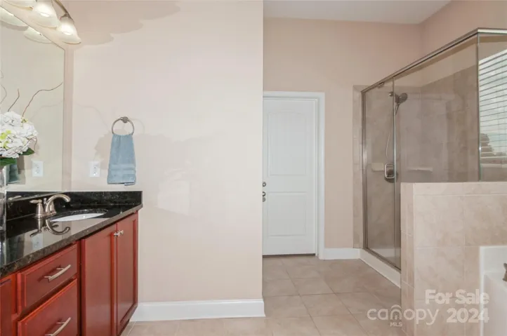 Primary Bathroom with Ceramic tile floors and Shower