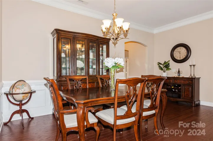 Formal Dining Room with Picture and Crown Molding. Dining Room opens to Living Room and Kitchen