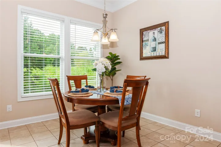 Breakfast area with tile flooring and crown molding