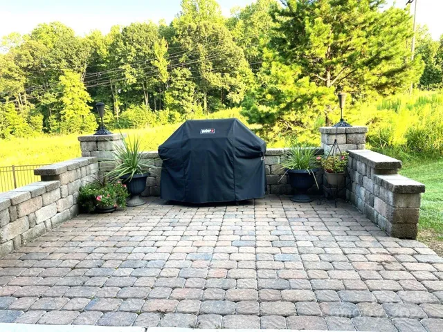 Custom stone patio looks on to private backyard