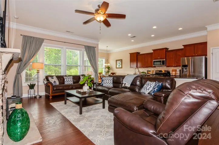 Living Room with ceiling fan, hardwoods and crown molding