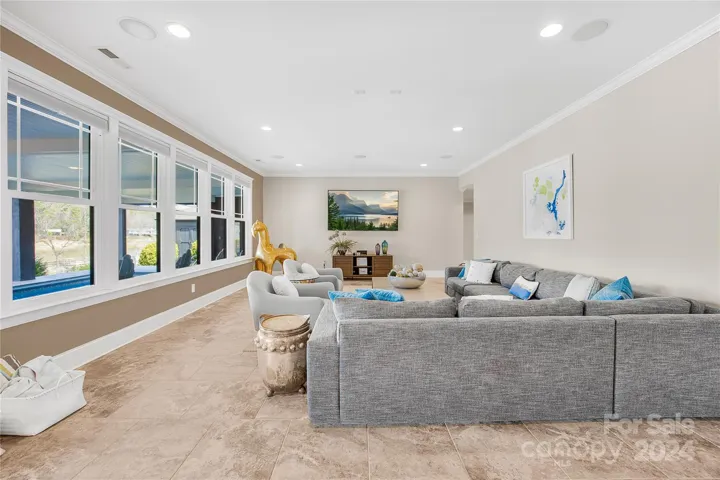 Lower level rec room with view of pool and lake