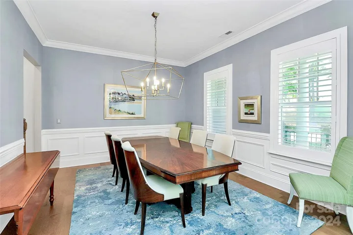 Spacious dining room with Schumacher grasscloth wall coverings.