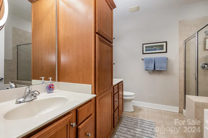 Primary Bath Ensuite with shower tub and ample storage space