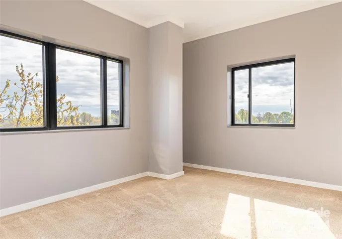 Enter the primary bedroom on your right eastern corner, with great light pouring in the windows!