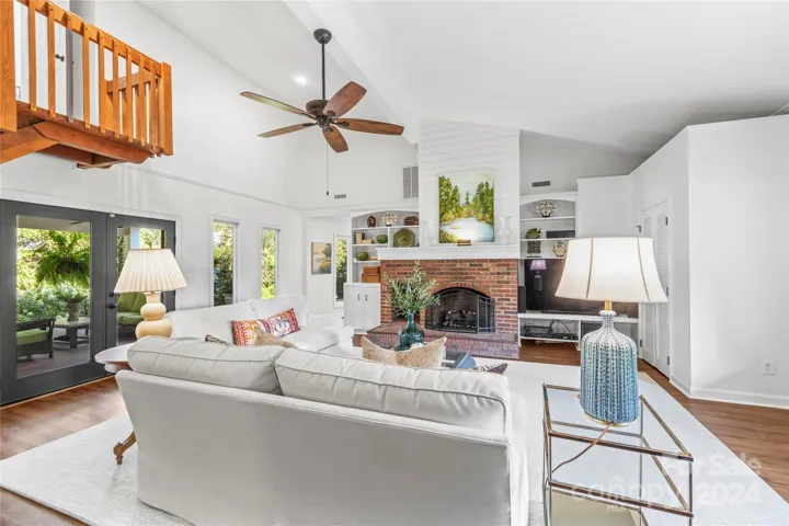 Custom built-ins and shiplap adorn the warm gas log fireplace