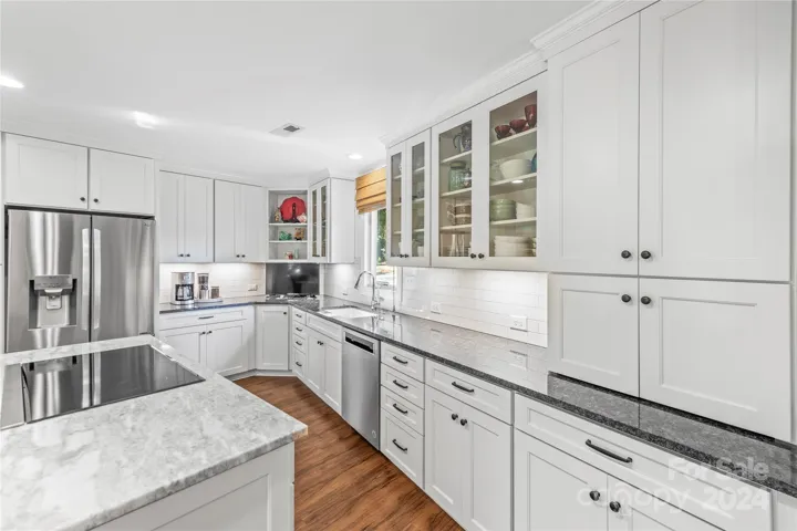 Granite counter tops, a tile back splash and SS appliances complement the crisp white cabinets