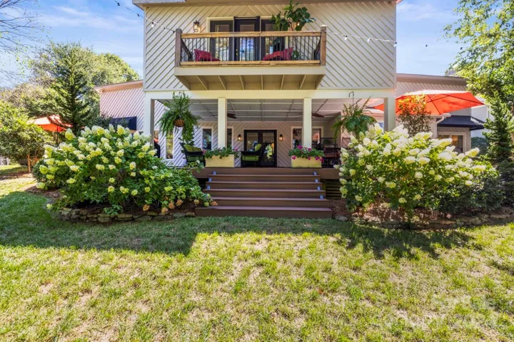 Enjoy the picturesque views from the expansive outdoor balcony and covered deck
