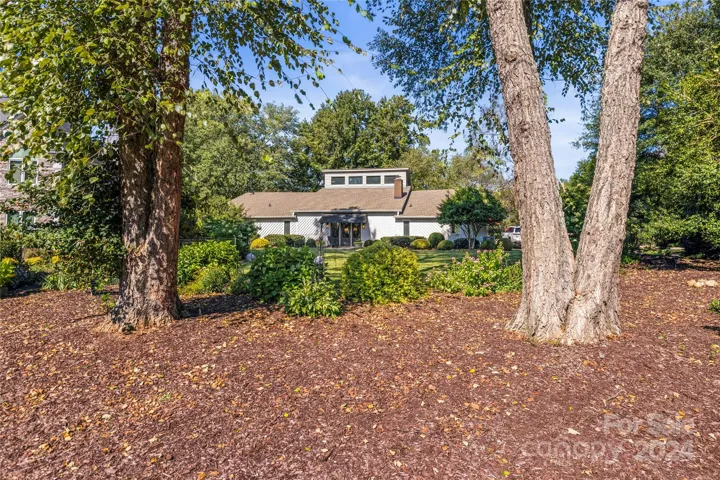 The view of the front of the home from the street shows how incredibly private and picturesque the grounds are maintained