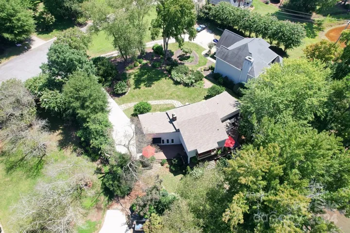 Aerial view of the home showing how perfectly it is nestled on the gorgeous lot