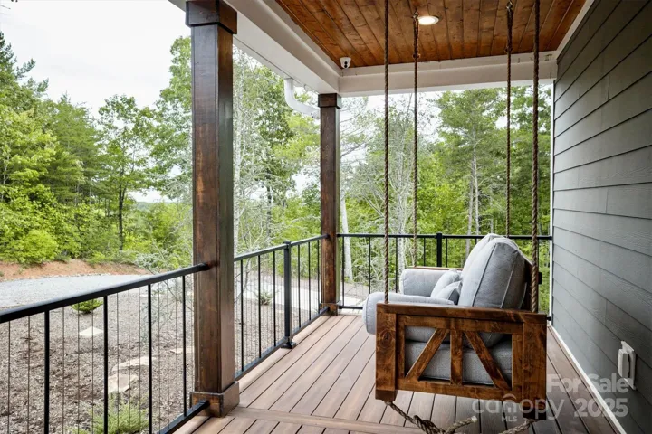 ~ Extra deep front and back porches with composite decking, porch swing/bed, rocking chairs, dining table, fire ring, sectional sofa, and metal roofs for relaxing during summer showers