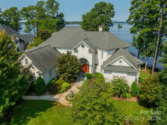 Aerial of the front of the home and lake