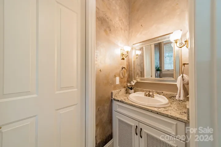 Half bath connecting to the outdoor screen porch, also accessible through laundry room