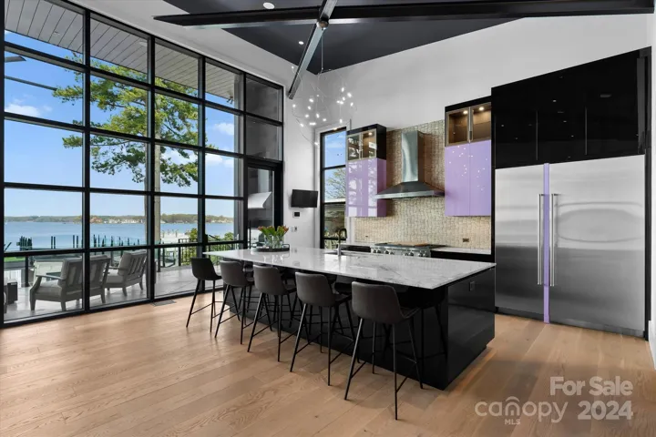 Artistic kitchen design featuring abstract steel beams, top-tier appliances, and bespoke Hans Krug cabinetry.